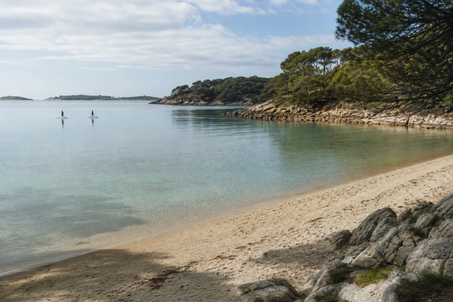 A sheltered cove with flat water, a sandy launch and no visible boat traffic.
